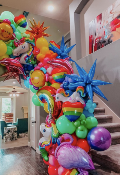Rainbow balloon garland on staircase