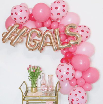 Pink balloon garland with gold bar cart for valentine