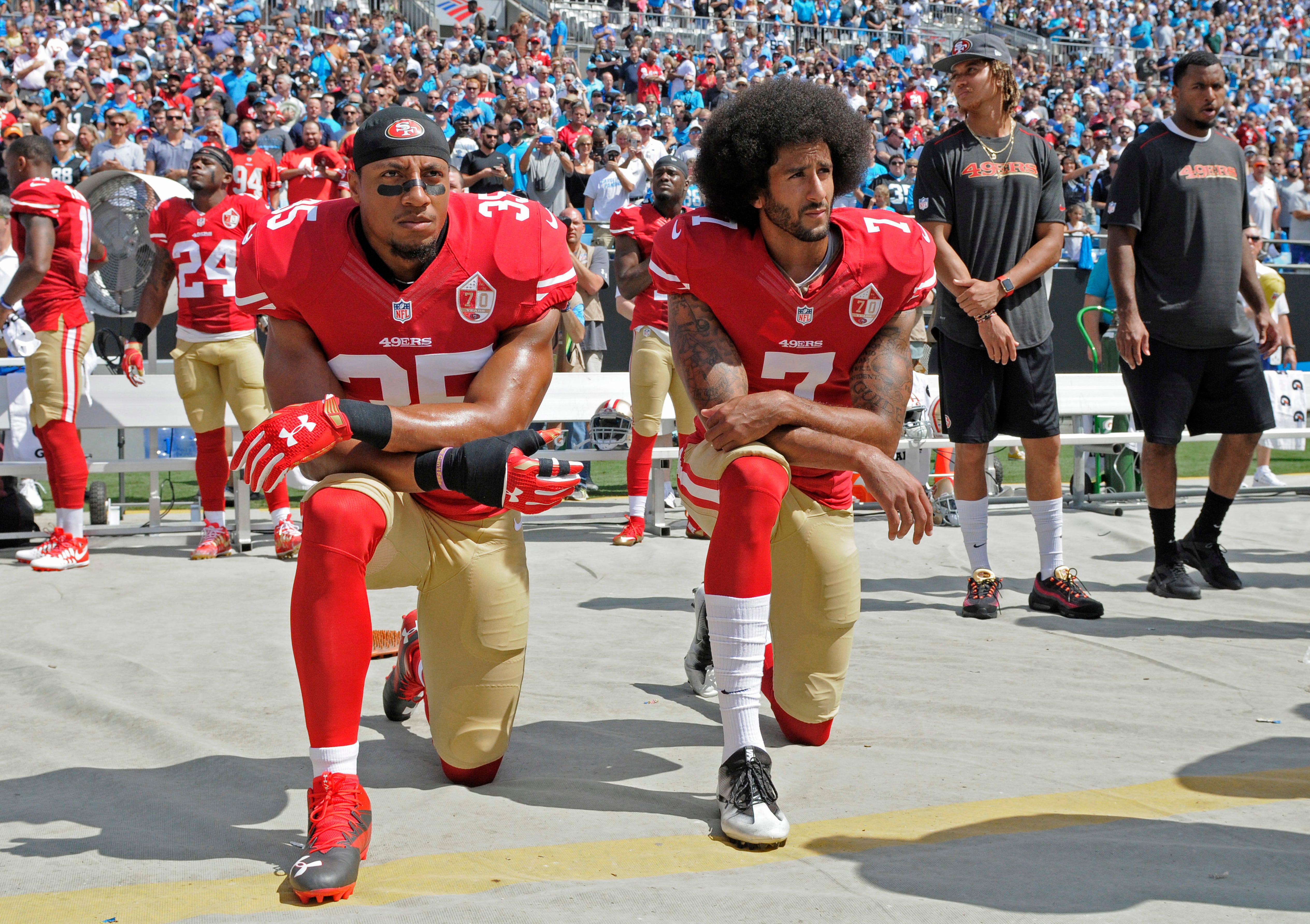 Colin Kaepernick (right) and Eric Reid kneel while singing the national anthem before the game at the San Francisco 49ers-Carolina Panthers on September 18, 2016.