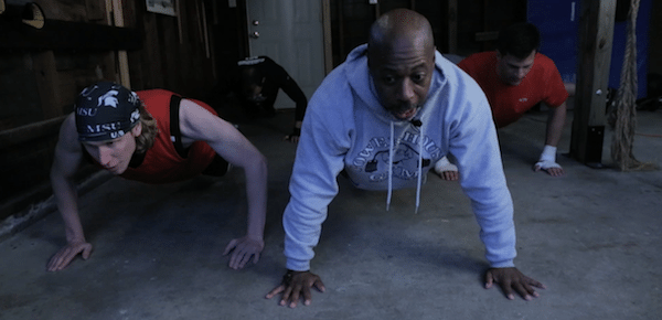 The men in the garage do the fight club push-ups at home.