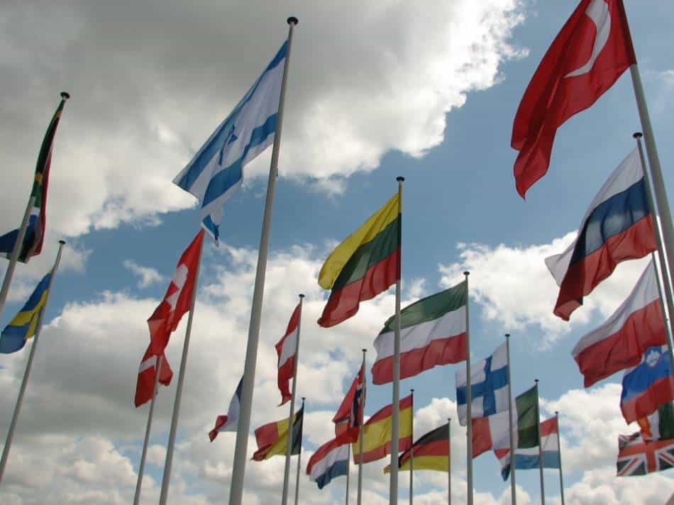 Country flag on flagpole on a cloudy day.