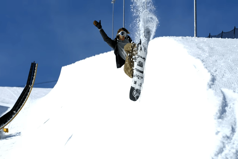 A skier poses for the camera among others.