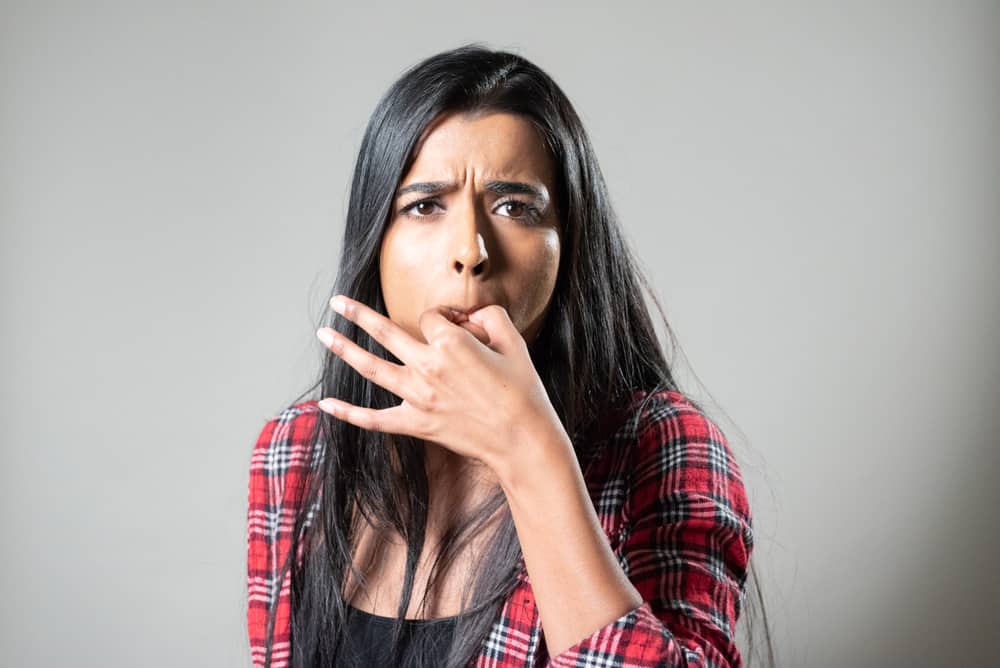 woman of color whistling on thumb and index finger