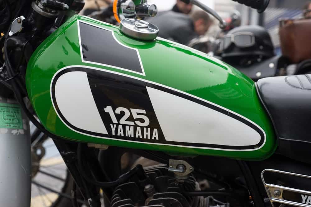 Closeup of Yamaha logo on green gas tank