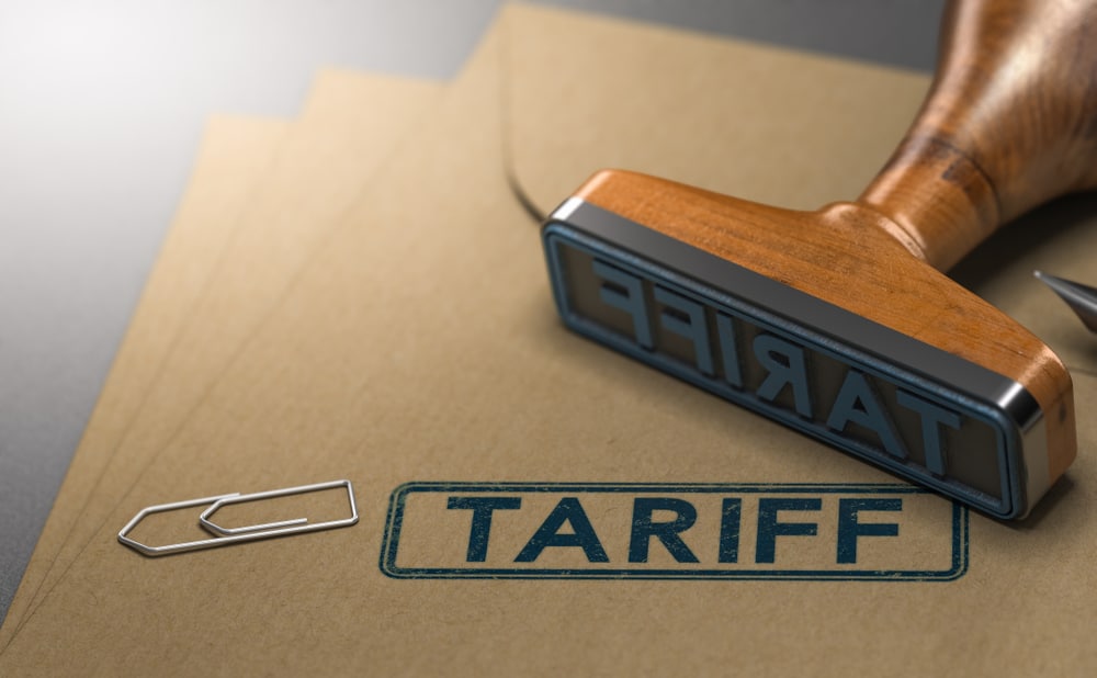 3D illustration of a rubber stamp with the word tariff stamped on paper background