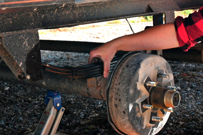 Use the top or bottom bolt to center the leaf spring on the axle mount.