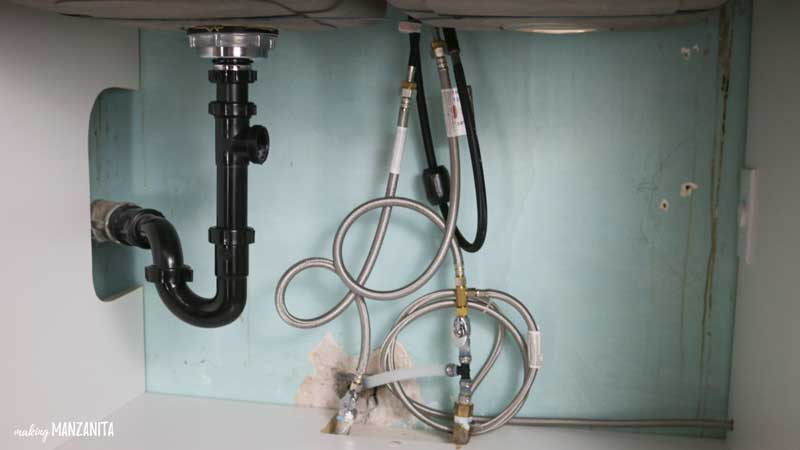 Remove the sink drain hose before installing a new garbage disposal system