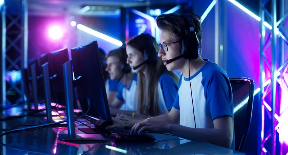 Team of Teenage Gamers Play in Multiplayer PC Video Game