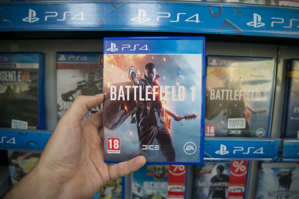Man holding Battlefield 1 videogame on Sony Playstation 4 console in store