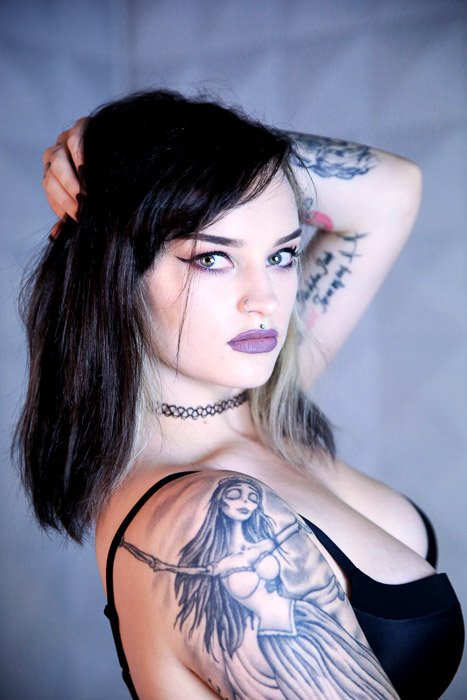 Close-up of a tattooed female model posing indoors - tattoo photoshoot