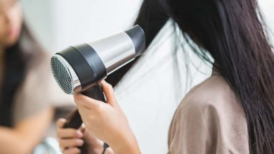 woman using hair dryer