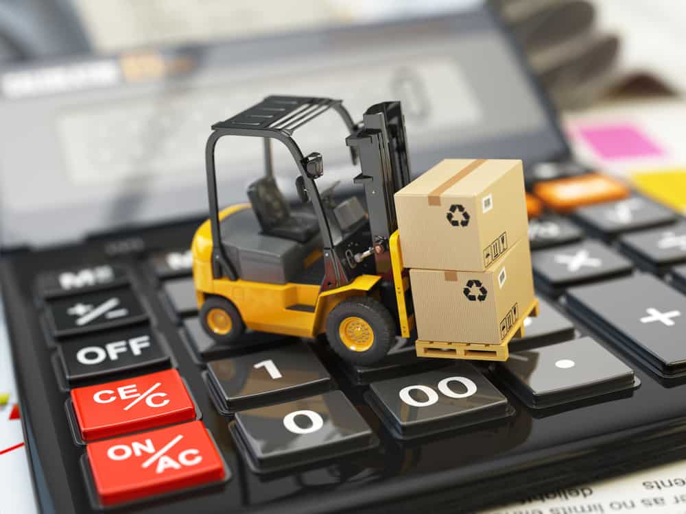 Forklift with cardboxes on calculator. Calculation of shipping