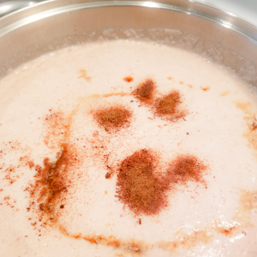 Pour sweetened condensed milk over Jamaica Peanut Porridge.