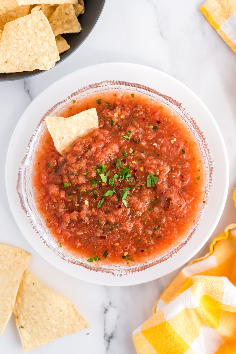 shot from above fresh salsa in a bowl surrounded by chips