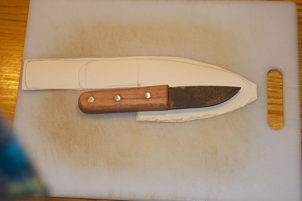 Vintage homemade knife and rough cut paper.