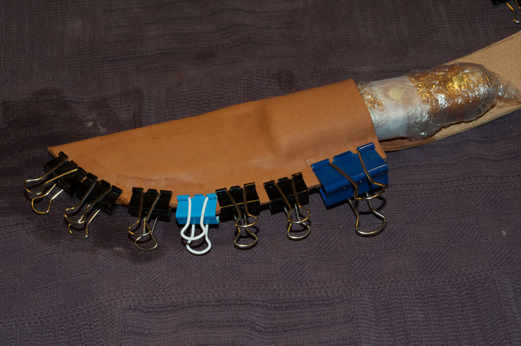 Vintage uses spring clamps, which clamp the leather into place.