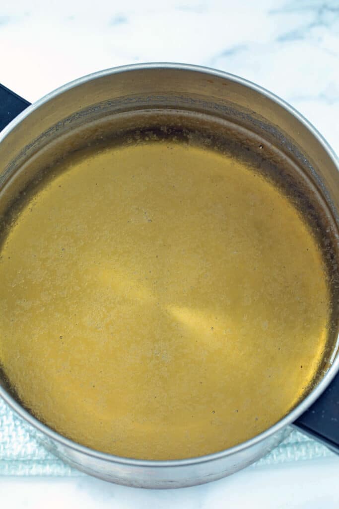 Sugar water solution simmering in saucepan