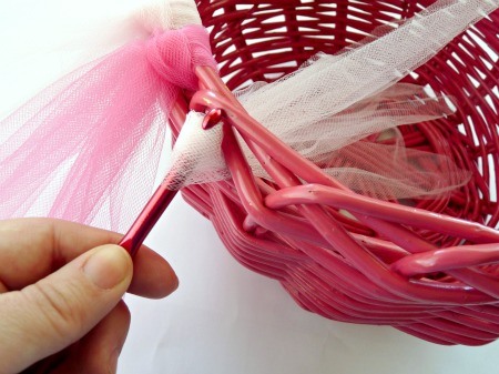 Use a crochet hook to pull the tulle