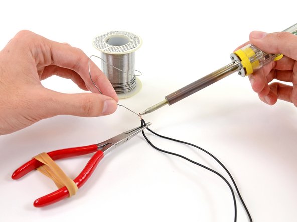 Hacking tool: thermostat with pliers and rubber bands
