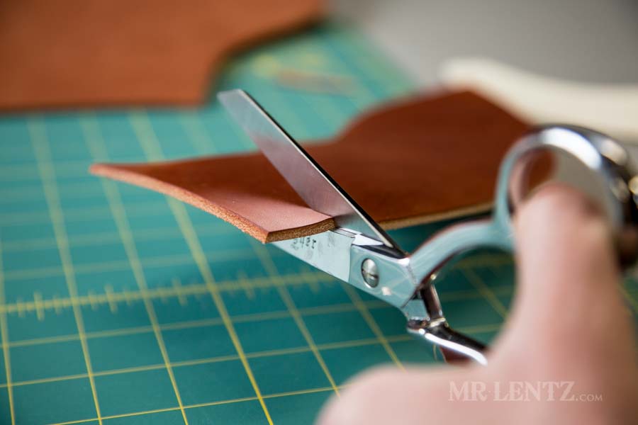 cutting leather to make an axe sheath