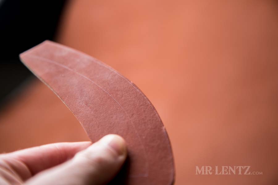 cutting leather to make an axe sheath