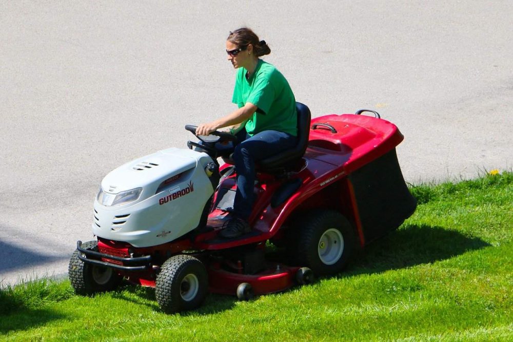 riding a fast lawn mower on the lawn