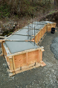 Before pouring concrete into the bridge footings, the Ford crew installed a grid of rebar that would tie the bridge footings together with the main beam supports.