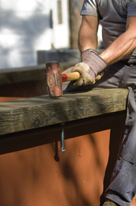 To mark the hole locations on the stringers, Mike put the bolts upside-down in the I-beams with a nut in place, positioned the stringer beams and then gave them a good hit or two with a sledge hammer, which caused the bolt to leave an indentation where he then drilled the bolt holes.