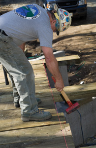 Mike stretched a string line from one side of the bridge to the other and then used a sledge hammer to line up the bridge deck boards on the downstream side of the bridge.