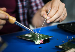 Hand soldering tin on electronic circuit board