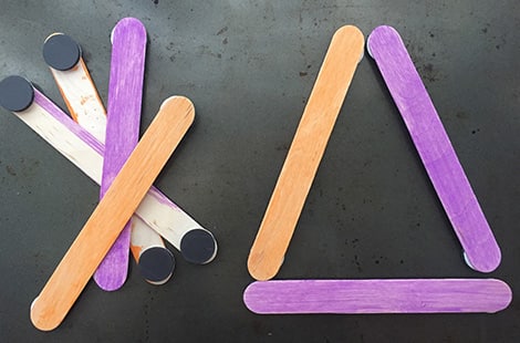 Colorful ice cream sticks with magnets at the ends forming a triangle.