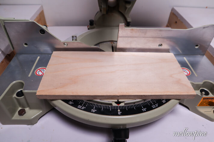 material placed on the bed of miter saw