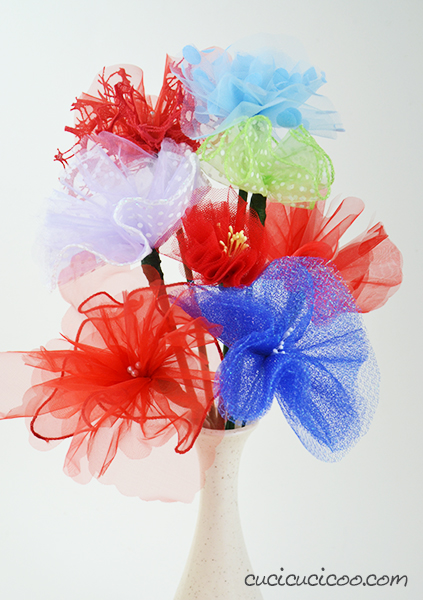 Use up scraps of tulle or upcycle party favor packaging to decorate your home. These DIY tulle flowers are super quick and easy to make and look great!