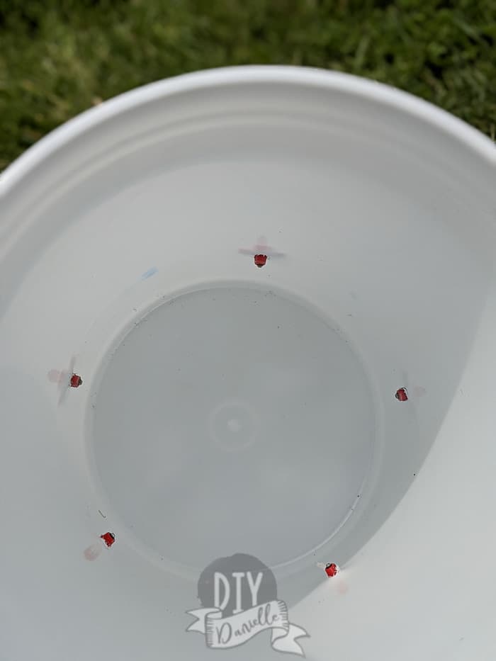 Screw the red nipple waterer into a white bucket.