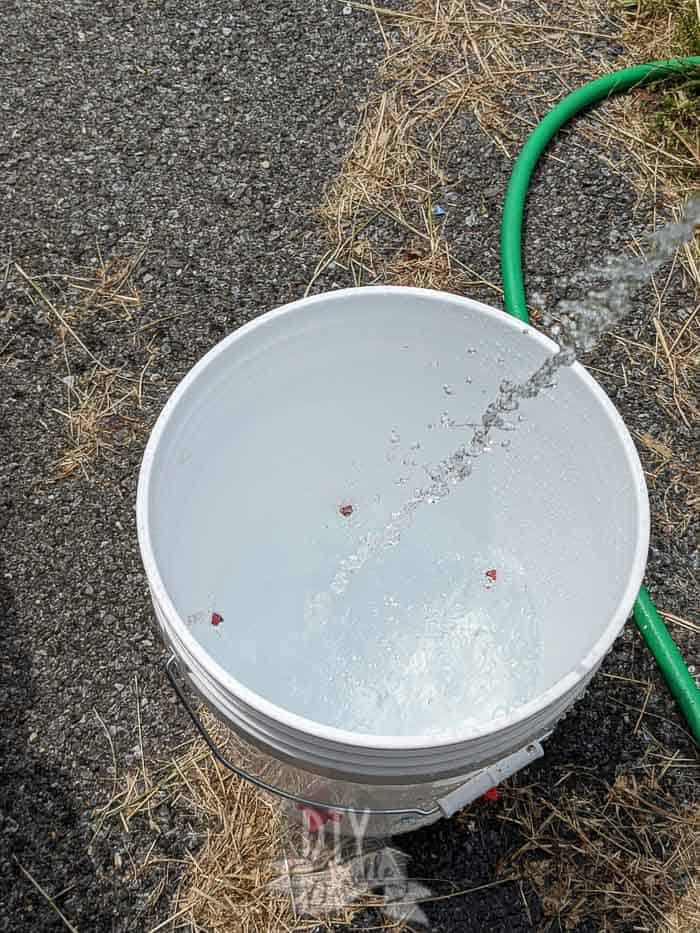 Make your own chicken waterer from a 5-gallon bucket, the chickens will drink water from it.