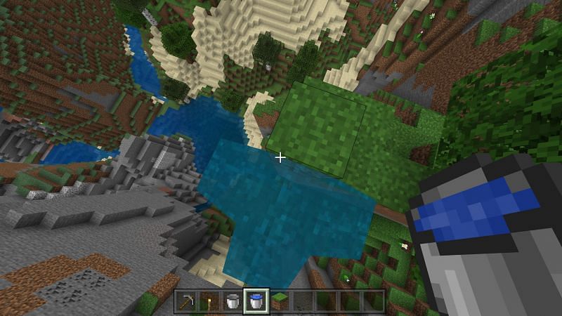 Step 2 to use water bucket to create waterfall for safe travel in Minecraft