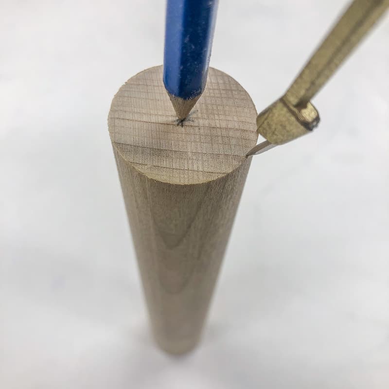 mark the center of a wooden dowel with a compass