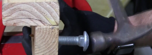 Smash the carriage bolt washer into a hole