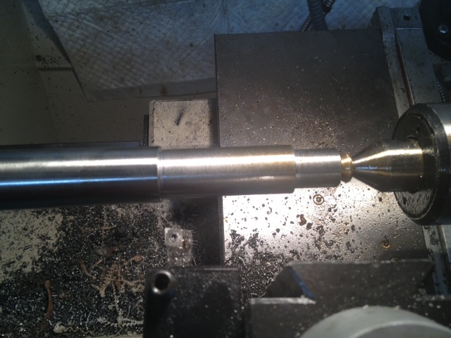 The lathe is revered and the mold removed. The threads are now aligned with the bore. Note: oil is on the camera lens.