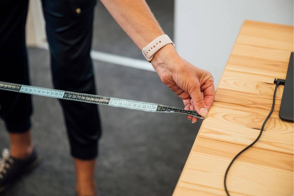 a woman measuring the distance