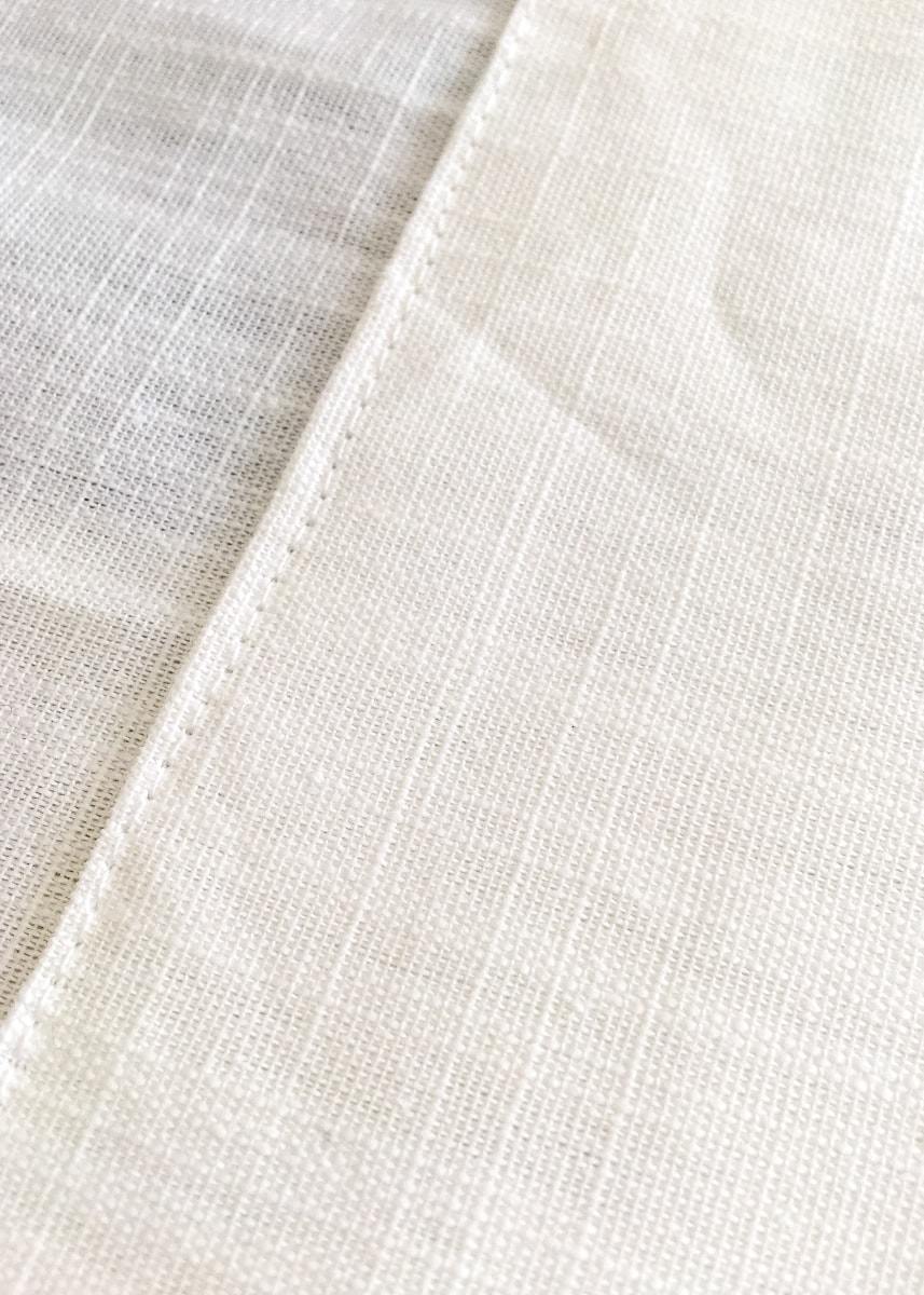 a close-up image of a border on a white curtain
