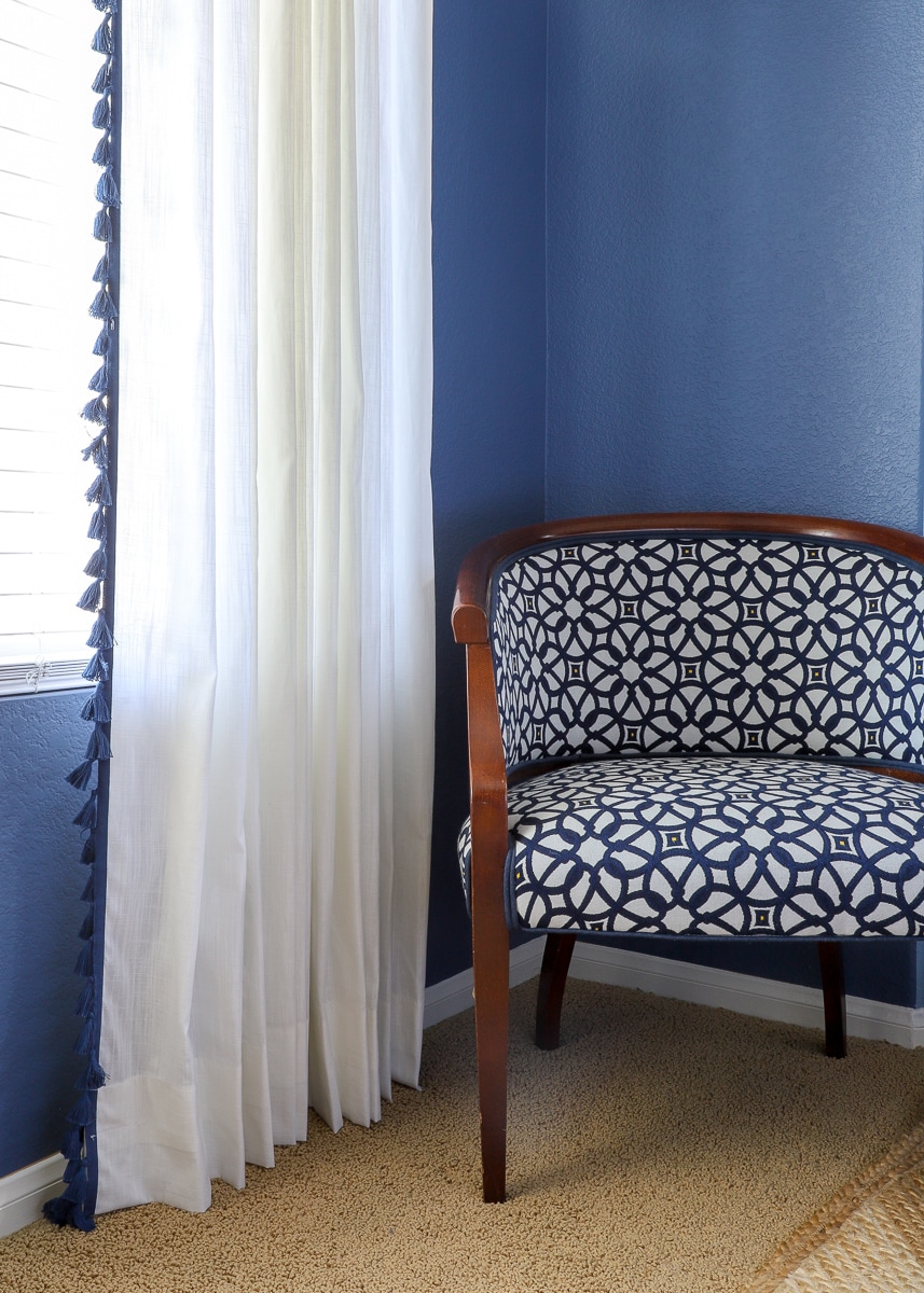 curtain hanging next to an accent chair