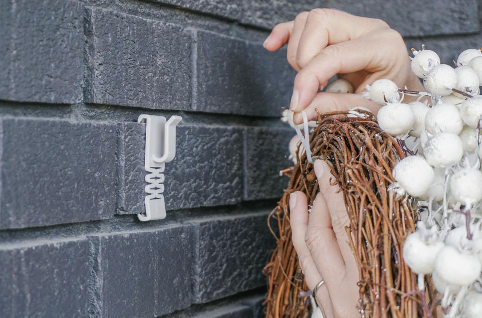 Use zip ties to hang the wreath on the brick