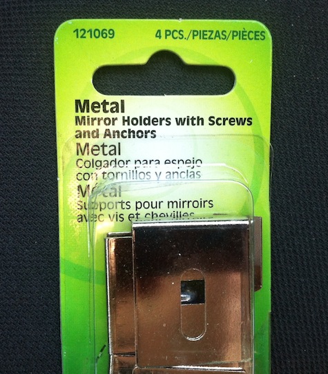 Metal mirror clip for mounting frameless mirrors.