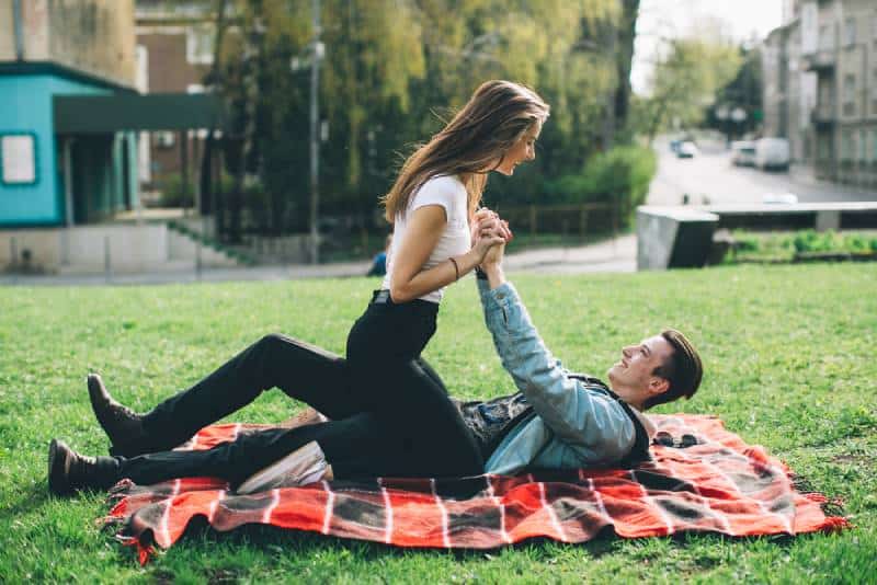 couple having a good time in the garden on the blanket
