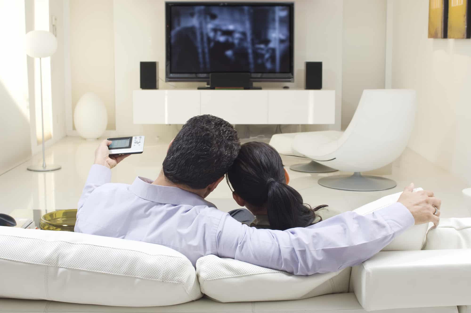 The couple watched cable TV on a high-definition TV with surround-sound speakers, cuddling on a white leather couch.