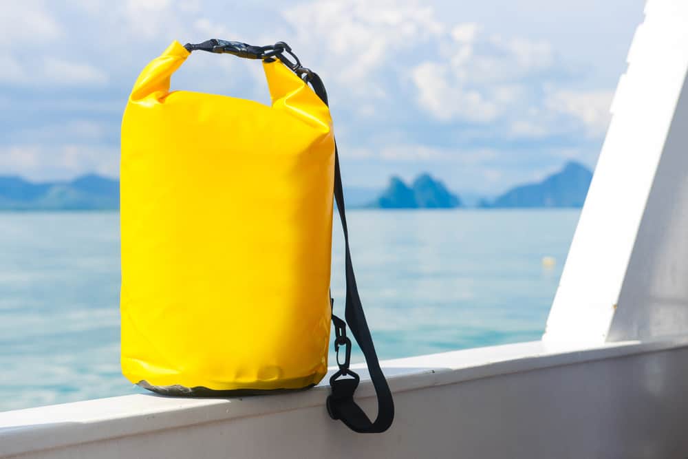 yellow waterproof bag for travel at the sea