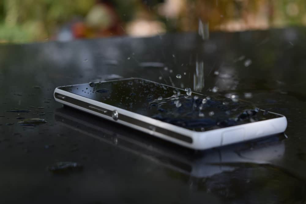 Water splashing on waterproof mobile phone.