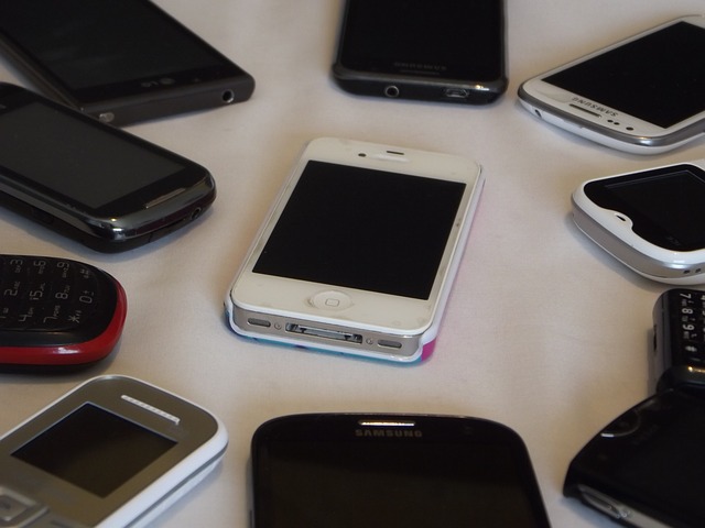 Image of an iPhone surrounded by other phones