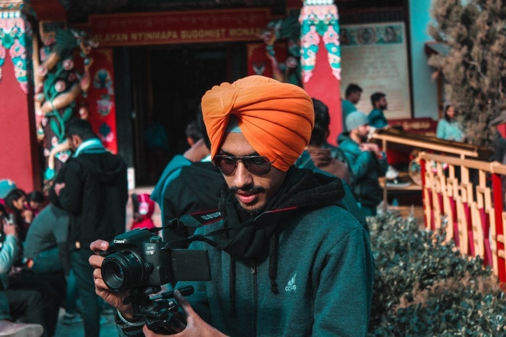 filmmaker in turban holding camera